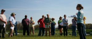 Amanda McWhirt shares research results during a field tour.