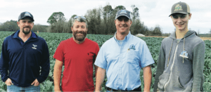 Joe Parker, left, with Georgia grower partner Brett Williams, Rafe Parker and Caleb Parker, Rafe’s oldest son, in a broccoli field