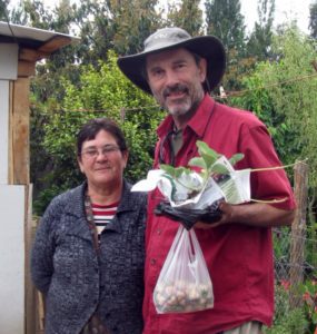 Tom Davis with a strawberry farmer