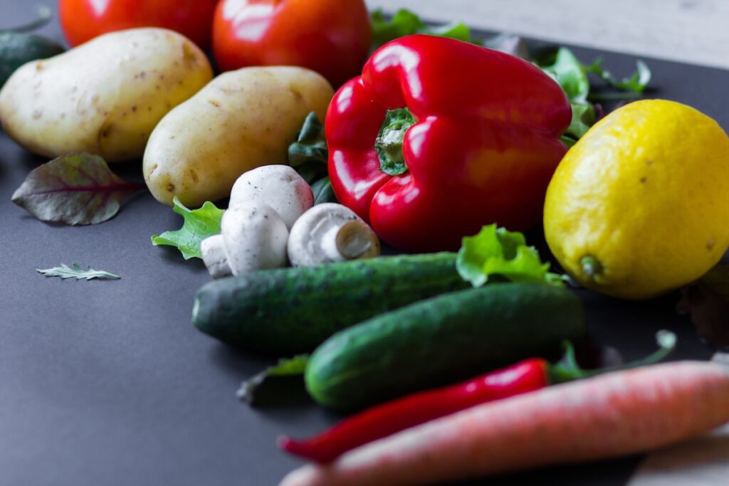 Assortment of colorful vegetables and mushrooms on a table.