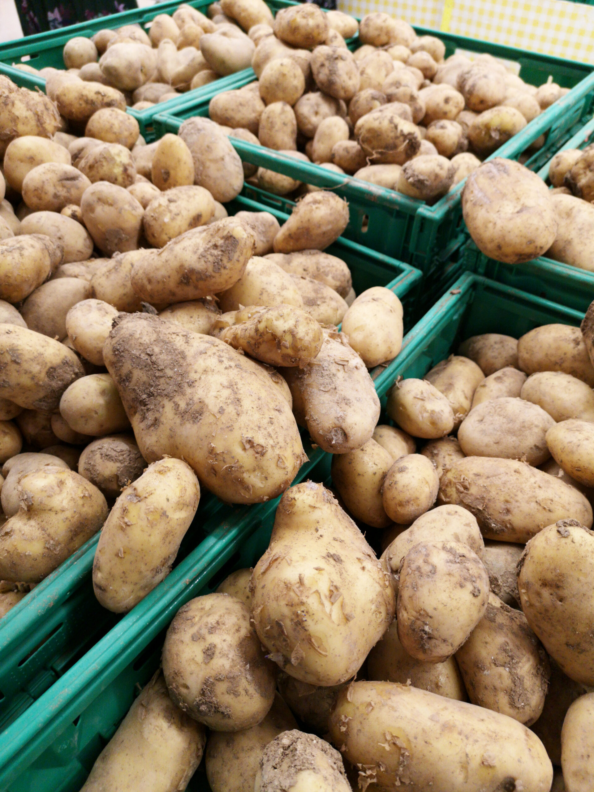 Green baskets containing fresh potatoes