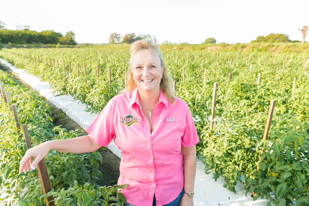 Marie Bedner of Bedner Growers in a field of mature green tomatoes.