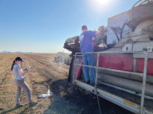 UC Davis researchers cleaning and sanitizing a tomato harvester to prevent the spread of branched broomrape seed