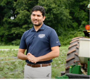 UConn Extension Vegetable Specialist Shuresh Ghimire at an on-farm trial testing a soil-biodegradable plastic mulch on tomato production. Photo courtesy of UConn Extension.