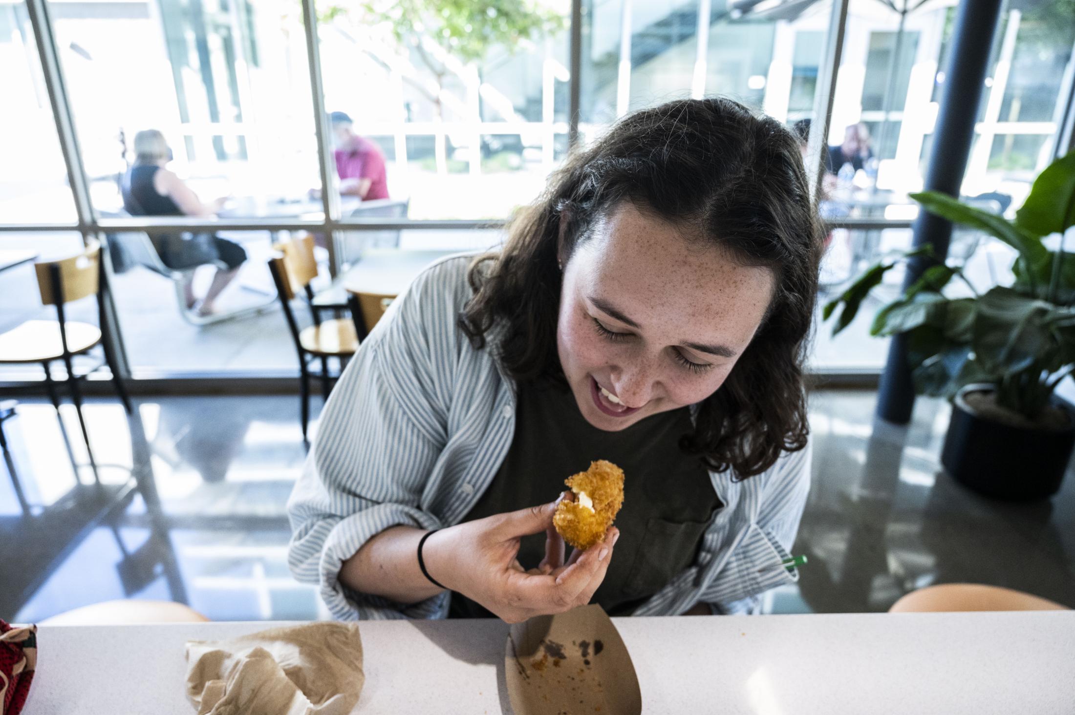 A staff member taste testing the jalapeño poppers.