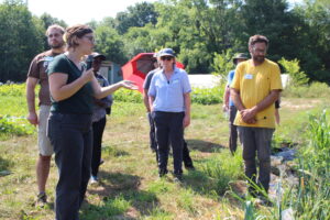 photo of man and woman addressing participants in field
